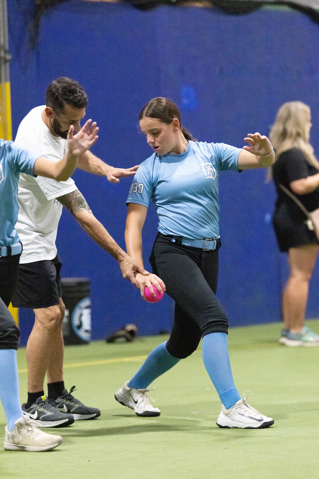 Athletes working through arm care and shoulder preparation at a clinic