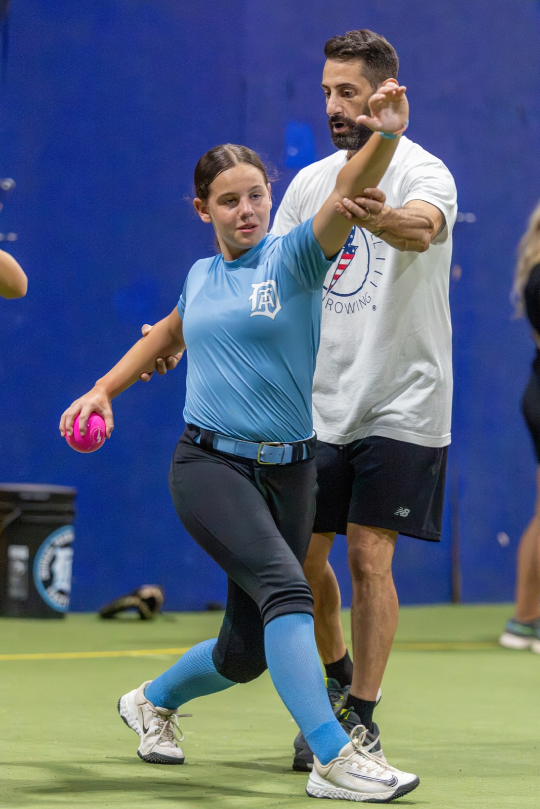 Athlete working with a Lightning Ball plyo alongside a High Level Throwing coach
