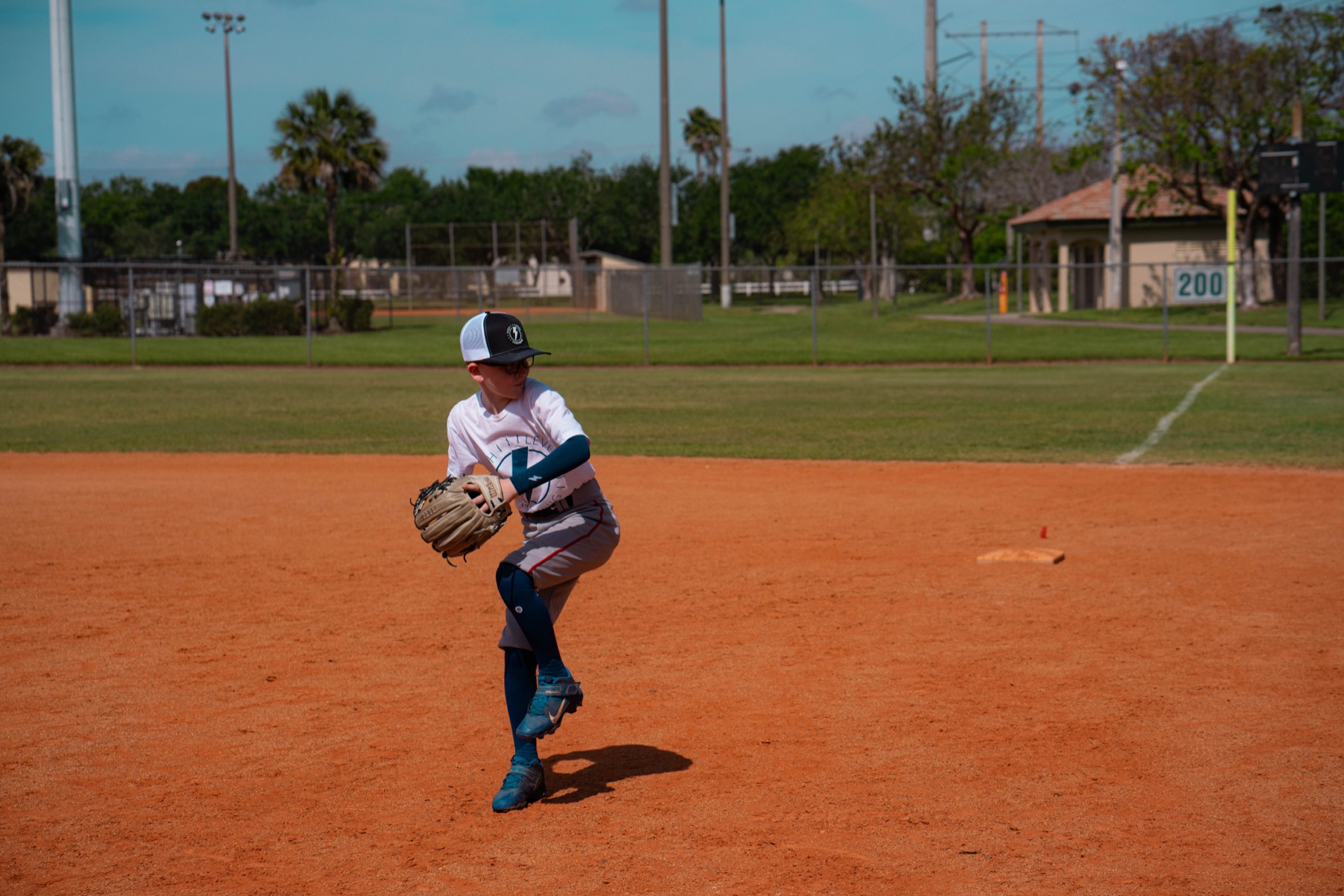 Young athlete throwing on the infield, the whole sequence from the ground up