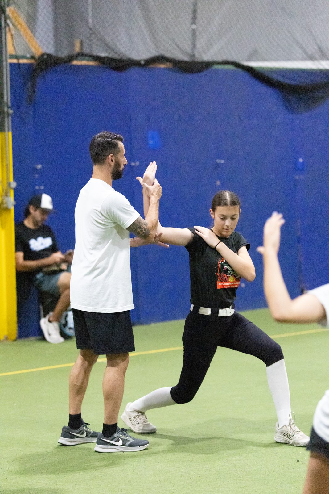 Austin Wasserman breaking a throwing position down for an athlete at a clinic