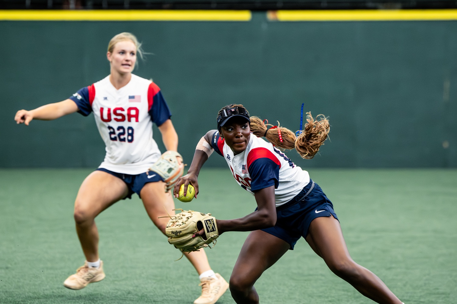 USA Softball athlete fielding and preparing to throw during camp