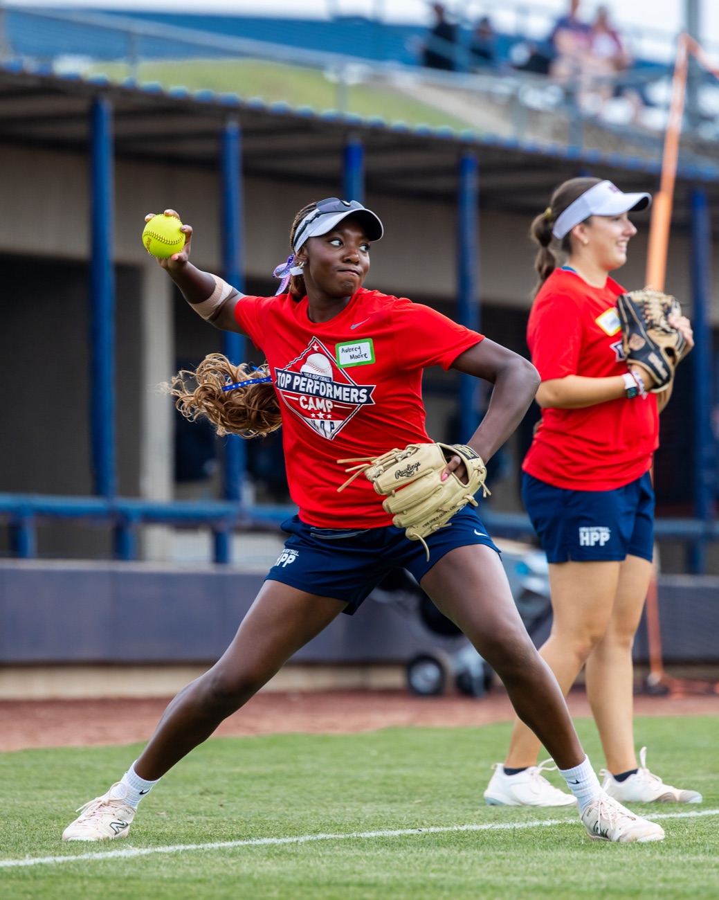 Softball athlete throwing overhand at the USA Softball High Performance Program camp