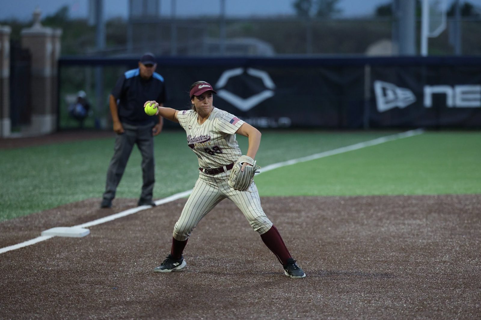 An infielder releasing a throw at the bag with a compact arm action