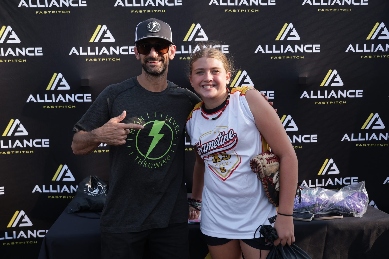 Austin Wasserman with an athlete at a High Level Throwing and Alliance Fastpitch event